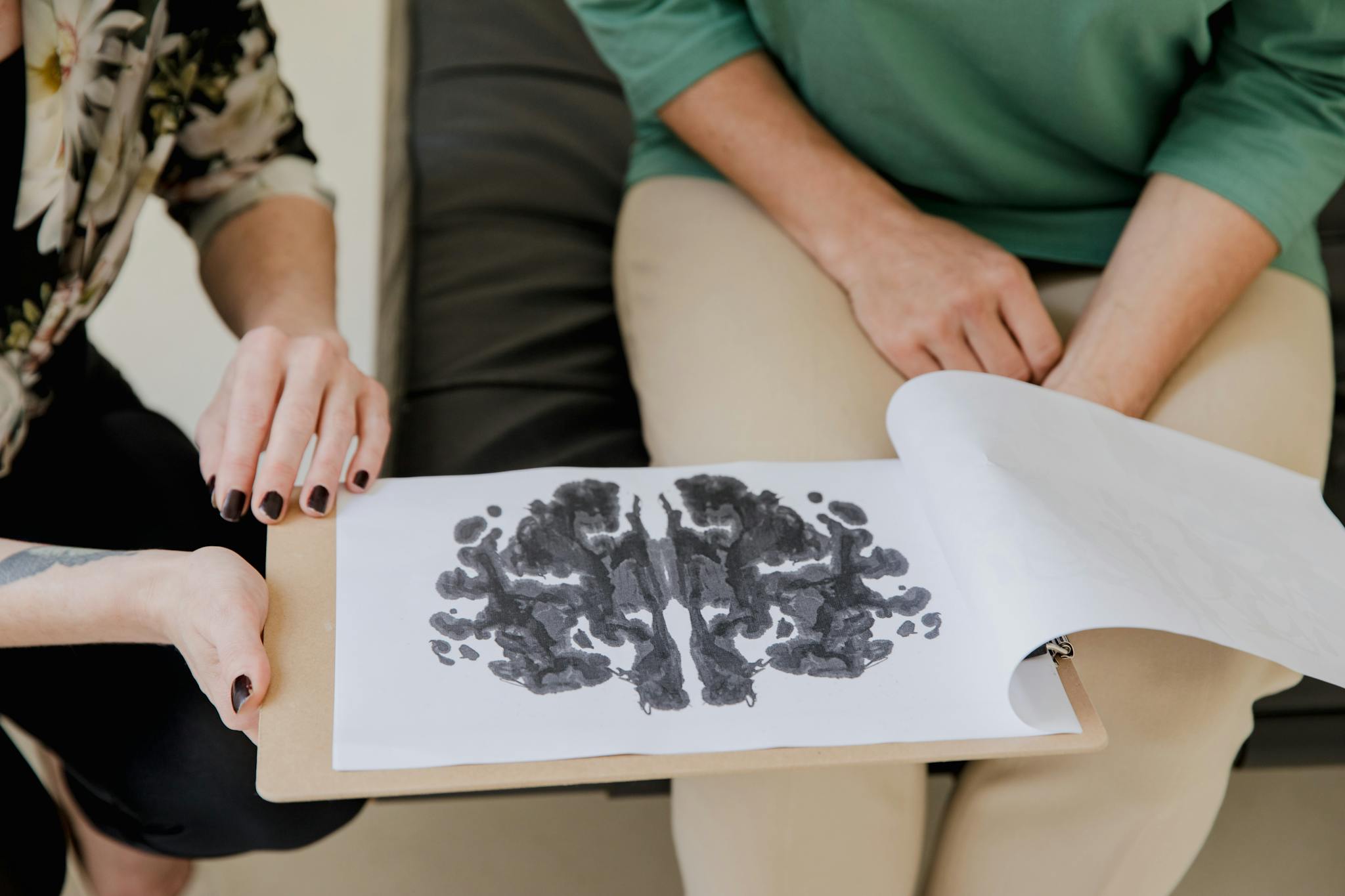 A close-up of a Rorschach inkblot test during a psychotherapy session, highlighting mental health care.